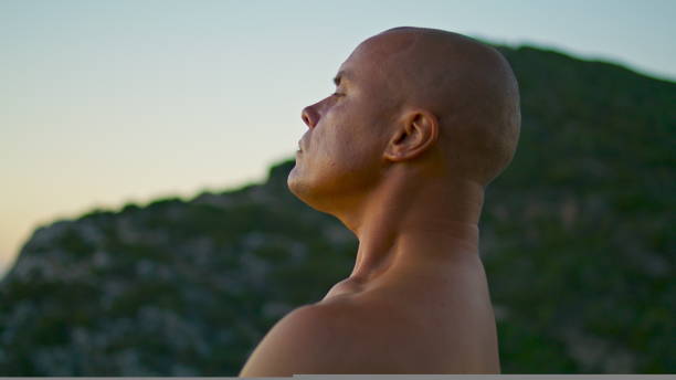 istock Closeup yogi meditating sunset at ocean view. Focused serene man practicing yoga 1440360394