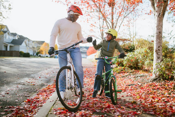 istock Father and Son Riding Bikes Together 1440362821