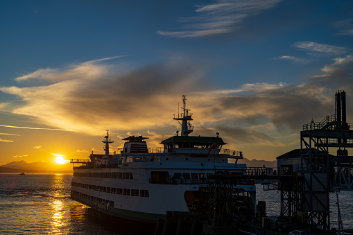 Seattle WA, USA - September 24, 2022: A Ferry at Pier 52 during sunset.