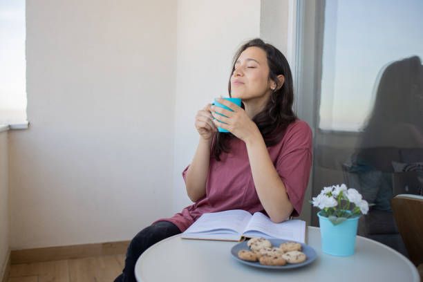 istock Young woman enjoying the sun on romantic balcony 1440375647