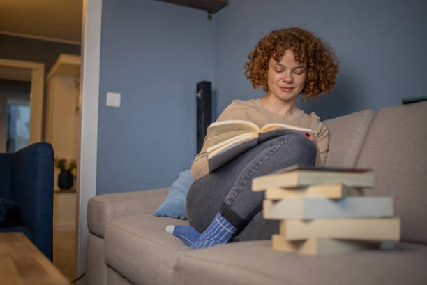 istock Woman relaxing and reading a book 1440376187