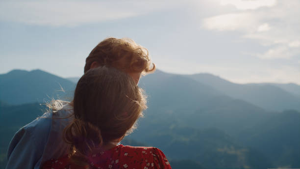 istock Fun couple enjoy mountains summer view. Happy lovers cuddle on nature vacation 1440376972