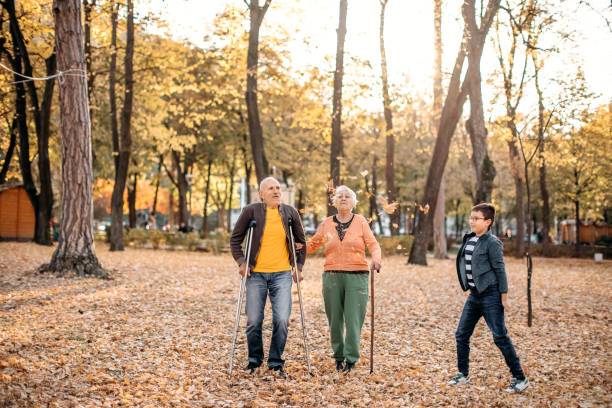 istock Old people with disabilities in public park 1440377547