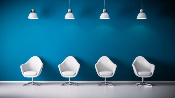 istock white chairs in front of blue wall 1440378224