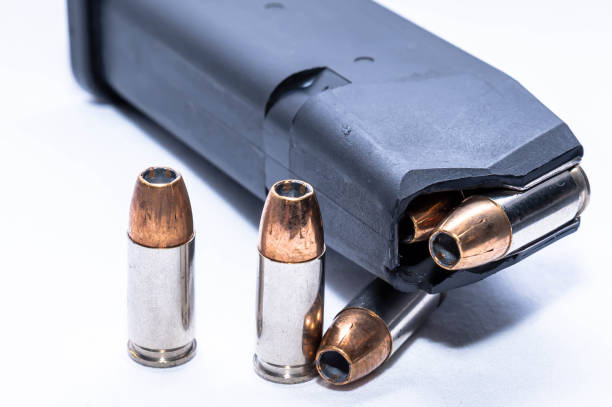 istock 9mm hollow point bullets loaded into a magazine with three next to it 1440378894