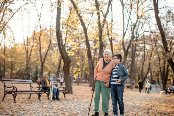 istock Old people with disabilities in public park 1440380480