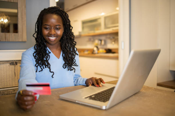 istock Cheerful  woman doing online shopping 1440383148