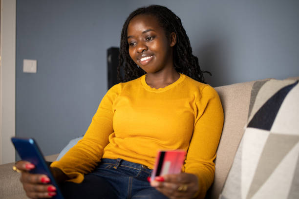 istock Cheerful  woman doing online shopping 1440383180