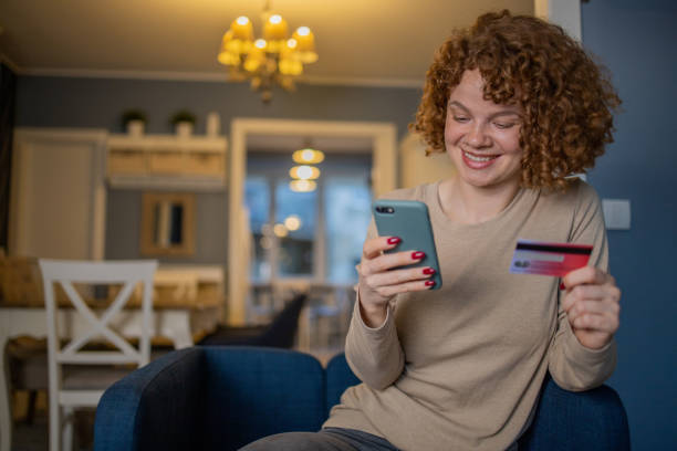 istock Cheerful  woman doing online shopping 1440383218