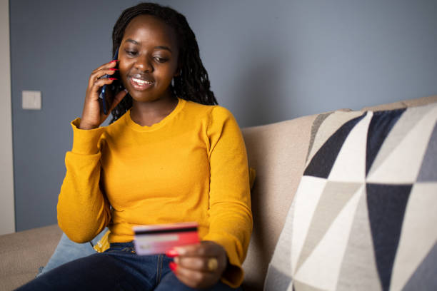 istock Cheerful  woman doing online shopping 1440383270