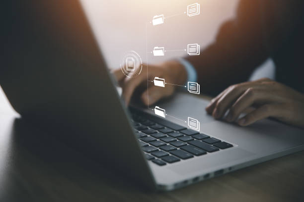 istock businessman use laptop to manage electronic documents The concept of efficient access to an online corporate business document database. 1440385830