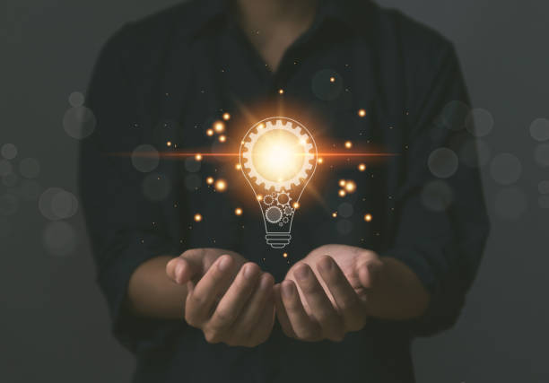 istock businessman holding a light bulb Digital technology. imagine an idea Creative and innovative. 1440385831