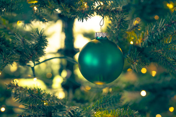 istock Shiny Christmas ball hanging on Christmas tree with festive background. 1440385908