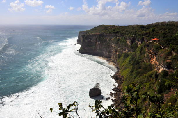 Bali, Indonesia-August 3, 2011: Bali is a charming vacation destination in South East Asia. Its uqique culture elements and diverse landscapes attracts tourists all over the World.  Here is the beach near Pura Luhur (Cliff) Uluwatu.