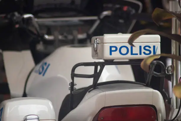 Photo of Indonesian police motorbike close up on police inscription (Indonesian)