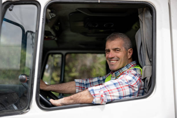 istock Driver looking very happy driving his truck 1440404324