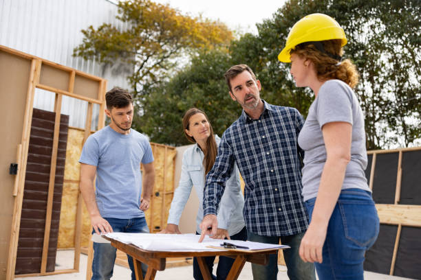 istock Project manager talking to his team about the blueprints at a construction site 1440404359