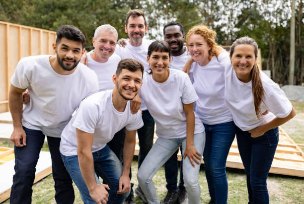 Happy group of volunteers smiling at a construction site