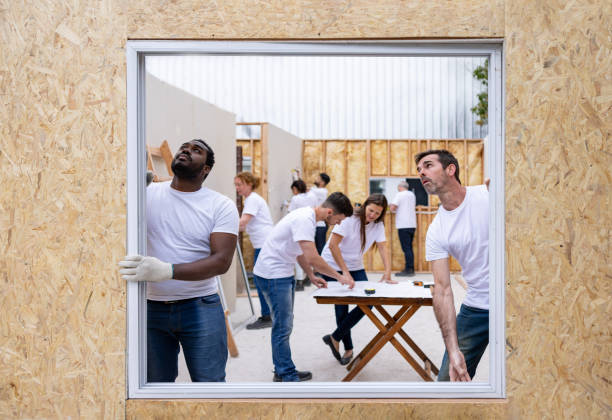 istock Volunteers installing a window while building a house 1440404421