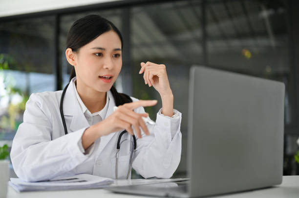 istock Professional Asian female doctor working in the office, using laptop computer. 1440405683