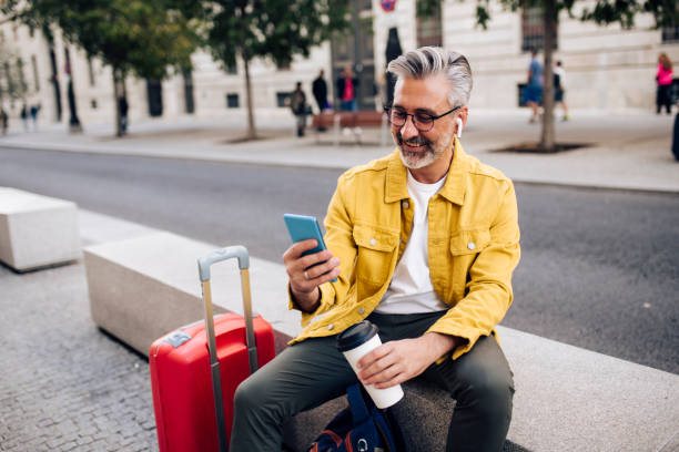 istock Mature tourist taking a coffee break and texting 1440408665