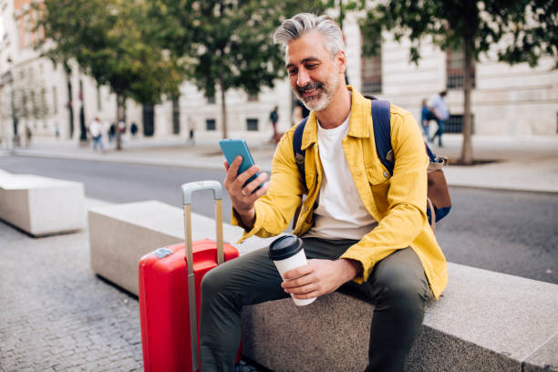 istock Mature tourist taking a coffee break and texting 1440408667