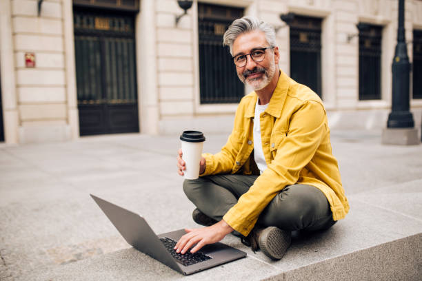 istock Mature tourist taking a coffee break and using laptop 1440408669