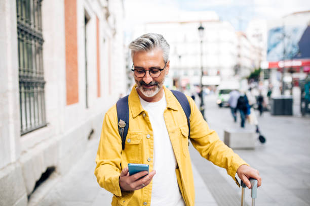 istock Mature man arriving to Madrid and using GPS for sightseeing 1440408679