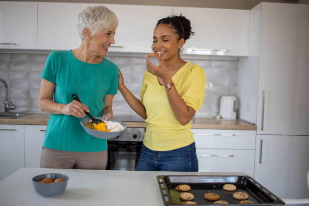 istock Mother and daughter making cookies 1440409868