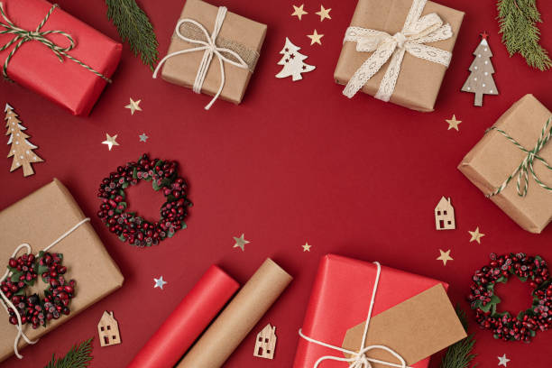 istock Christmas background with gift boxes and rolls of kraft wrapping paper 1440410442