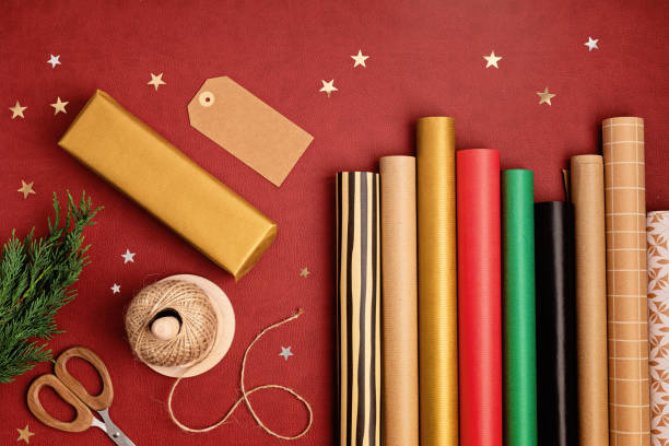 istock Christmas background with gift boxes and rolls of kraft wrapping paper 1440410444