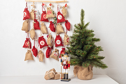 Handmade advent calendar. Gift bags hanging on the rope. Eco friendly Christmas gifts diy concept