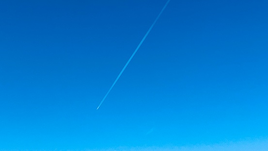 An airplane over the blue sky