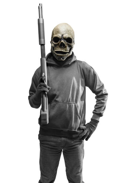 istock Man with a skull head costume for Halloween holding gun 1440411724
