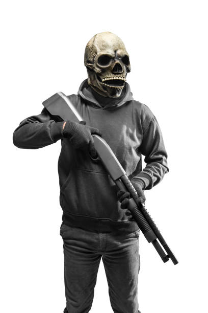 istock Man with a skull head costume for Halloween holding gun 1440411863