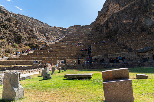 Cuzco, Peru - August 14, 2022: tourists walking and looking at the Ollantaytambo ruins in Cusco