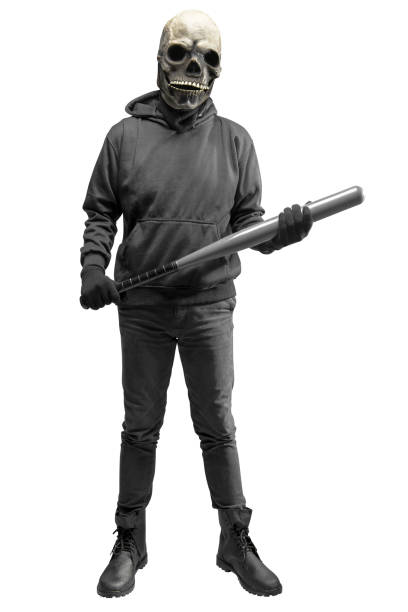 istock Man with a skull head costume for Halloween holding baseball bat 1440415105