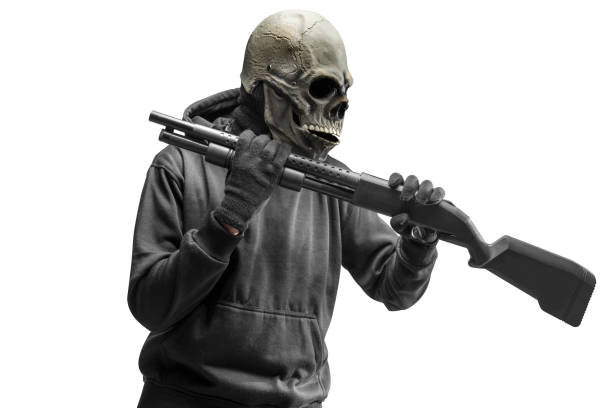 istock Man with a skull head costume for Halloween holding gun 1440415155