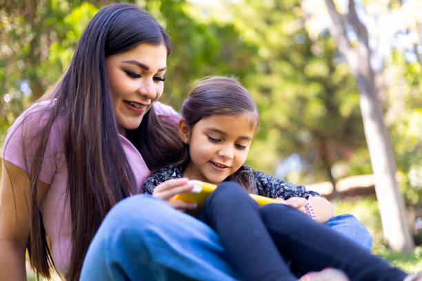 istock Mom and daughter playing video games 1440419690