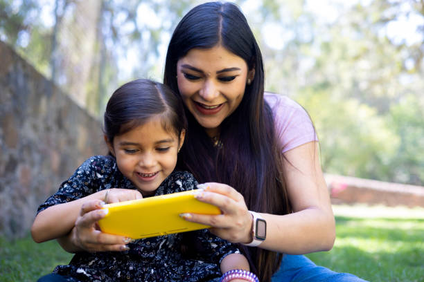 istock Mom and daughter playing video games 1440420972