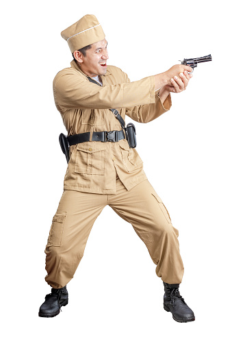 Indonesian freedom fighter standing while holding gun isolated over white background