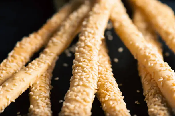 Grissini with Sesame Seeds, also known as breadsticks, grissino, or dipping sticks, are generally pencil-sized sticks of crisp, dry-baked bread originating in Italy.