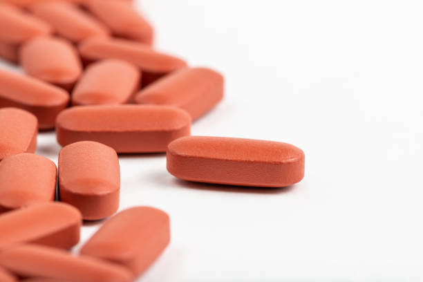 istock Orange medical pills on white background with copy space 1440425179