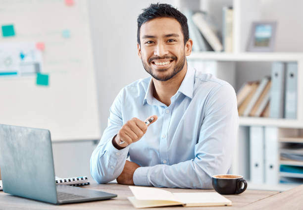 istock Success, work and a happy young businessman in his office at a startup. Planning, notes and research, a business coach preparing for a presentation. Tech, internet and a smile, working at a computer. 1440426103