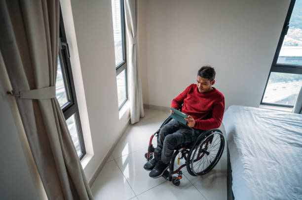 istock Working at home. Disabled Asian man communicating online. 1440427948