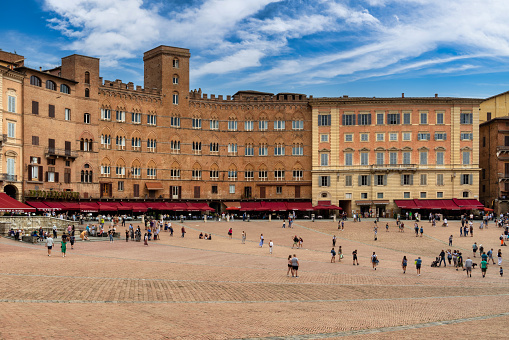 Siena, Piazza del Campo square, Torre del Mangia tower and Palazzo Pubblico building. Tuscany, Italy.