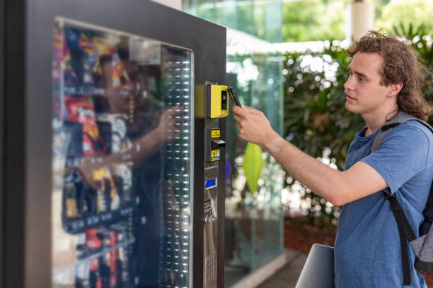 istock Person making a digital payment at a vending machine 1440430709
