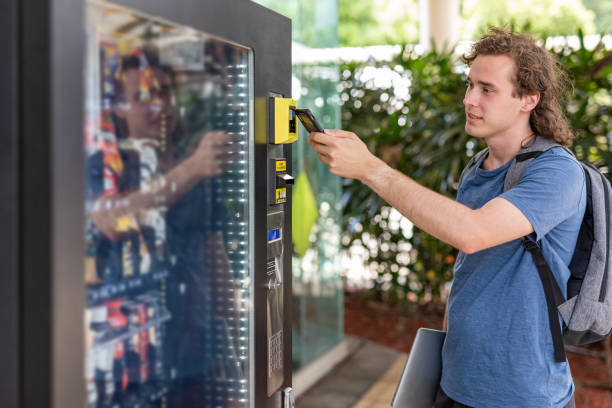 istock Person making a digital payment at a vending machine 1440430714