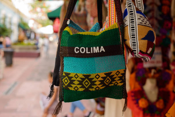 istock Backpacks, purses and handbags made with typical Mexican fabrics hanging outside souvenir stores. 1440431795