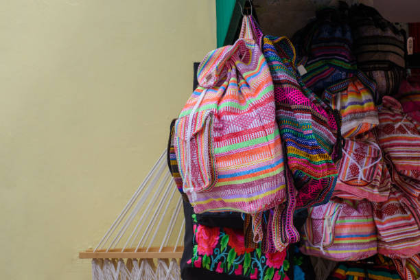 istock Backpacks, purses and handbags made with typical Mexican fabrics hanging outside souvenir stores. 1440431804